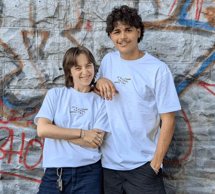 Two people wearing It’s Cool To Cry T-shirts